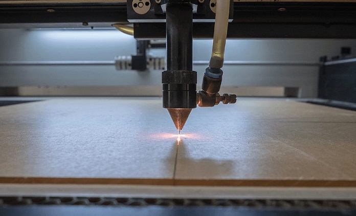 a laser cutter working on wood