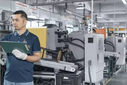 worker operating die casting machine
